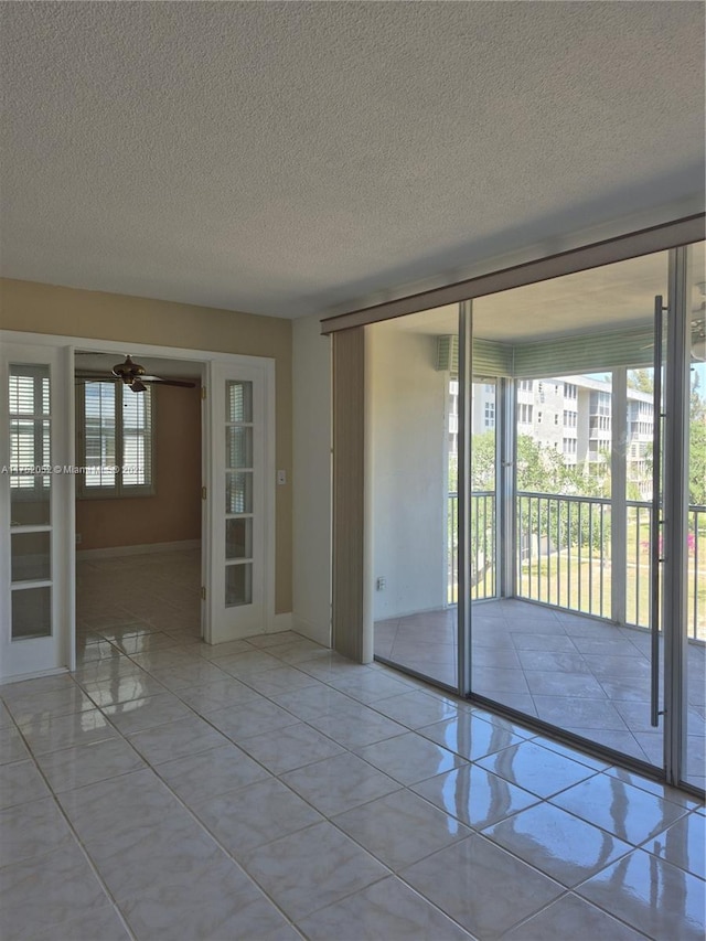 2650 S Course Dr Unit 410, Pompano Beach, FL 33069 - empty room featuring french doors and a textured ceiling