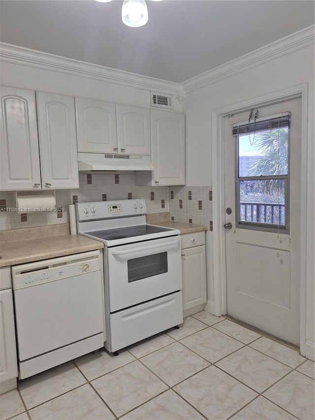 2650 S Course Dr Unit 410, Pompano Beach, FL 33069 - kitchen with white appliances, ornamental molding, under cabinet range hood, white cabinets, and light countertops