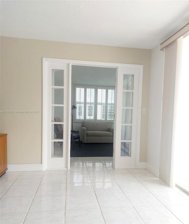 2650 S Course Dr Unit 410, Pompano Beach, FL 33069 - unfurnished room with french doors and light tile patterned flooring