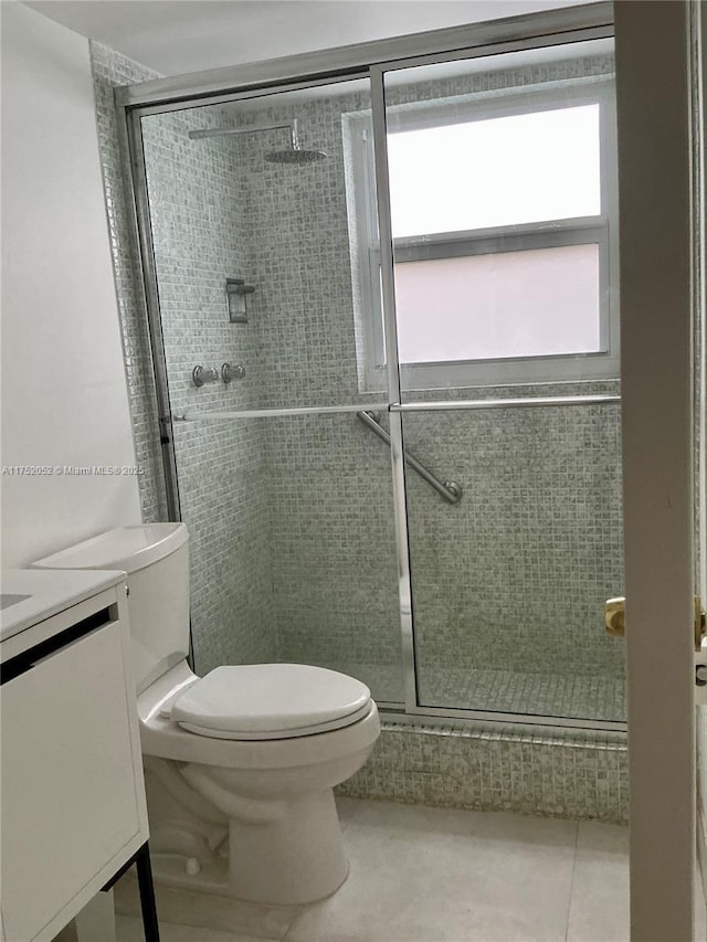 full bath featuring toilet, a shower stall, tile patterned flooring, and vanity