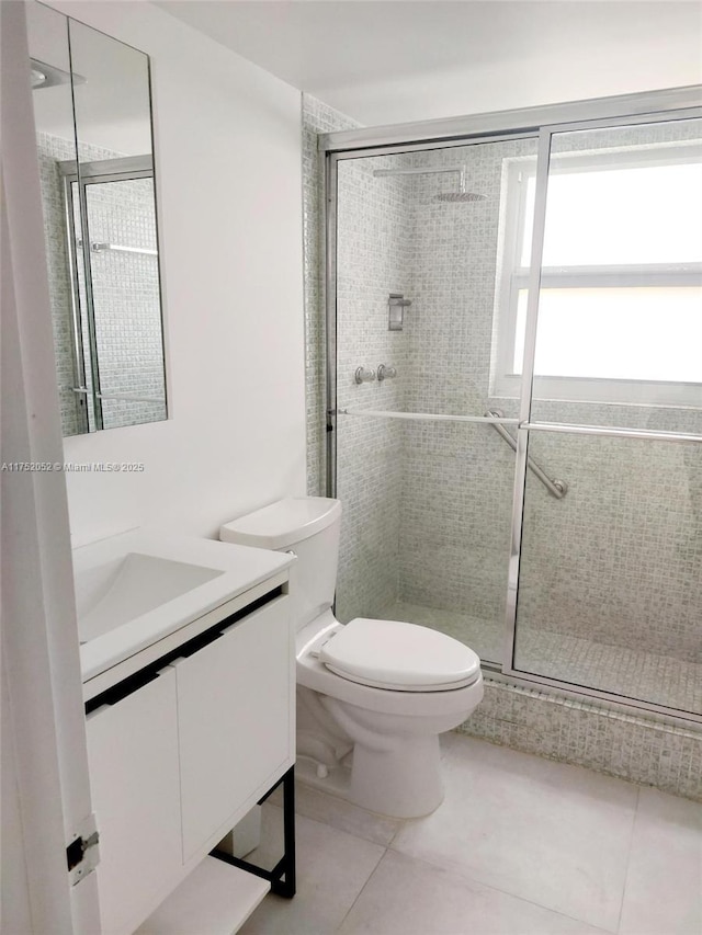 2650 S Course Dr Unit 410, Pompano Beach, FL 33069 - full bath featuring toilet, vanity, tile patterned flooring, and a shower stall