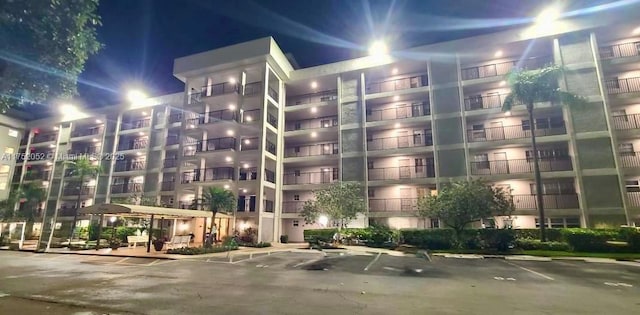 2650 S Course Dr Unit 410, Pompano Beach, FL 33069 - property at twilight featuring a view of apartment building / complex