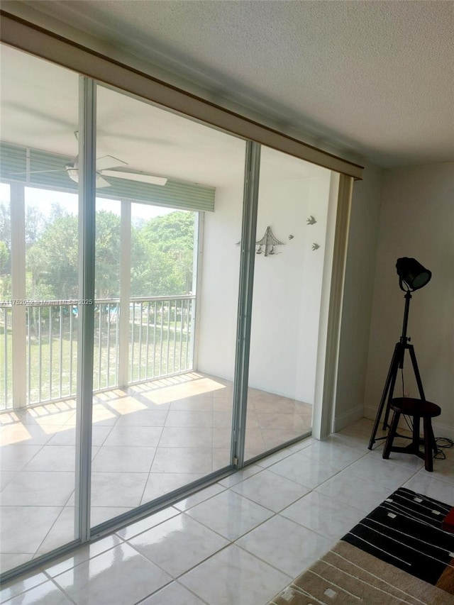 2650 S Course Dr Unit 410, Pompano Beach, FL 33069 - doorway to outside with a textured ceiling, ceiling fan, and tile patterned floors