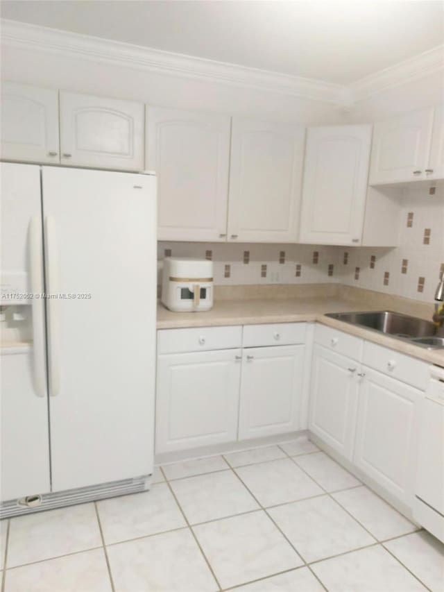 2650 S Course Dr Unit 410, Pompano Beach, FL 33069 - kitchen featuring white appliances, ornamental molding, a sink, and white cabinets