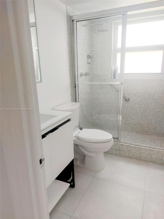 2650 S Course Dr Unit 410, Pompano Beach, FL 33069 - full bathroom with tile patterned floors, vanity, toilet, and a stall shower
