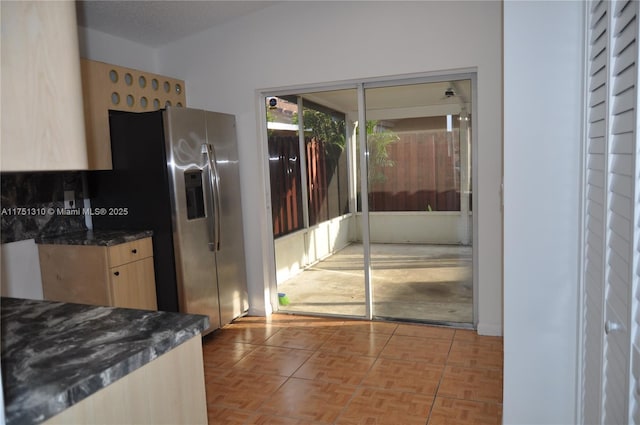 kitchen featuring stainless steel fridge and light brown cabinets