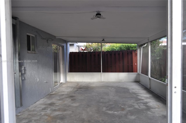 view of patio / terrace with ceiling fan and fence