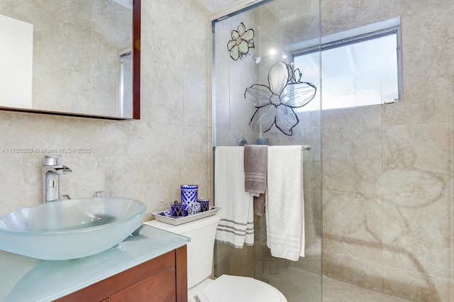 full bath featuring tile walls, vanity, toilet, and a walk in shower