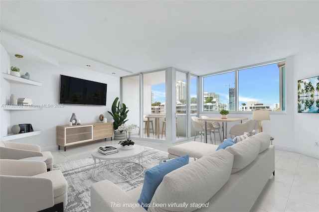 living room featuring a healthy amount of sunlight and baseboards