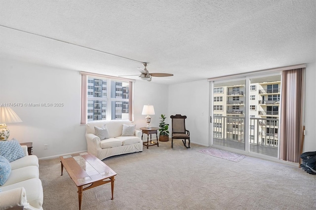 living area with light carpet, a textured ceiling, and baseboards