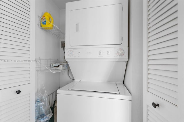 clothes washing area featuring laundry area and stacked washer / dryer