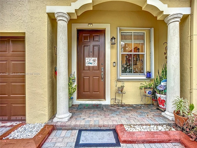 view of exterior entry with stucco siding