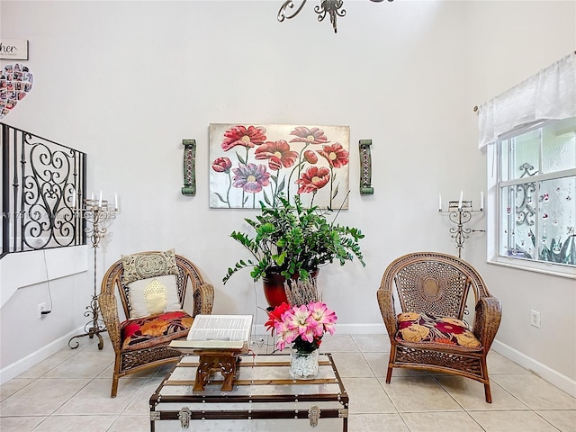 living area featuring baseboards and light tile patterned floors