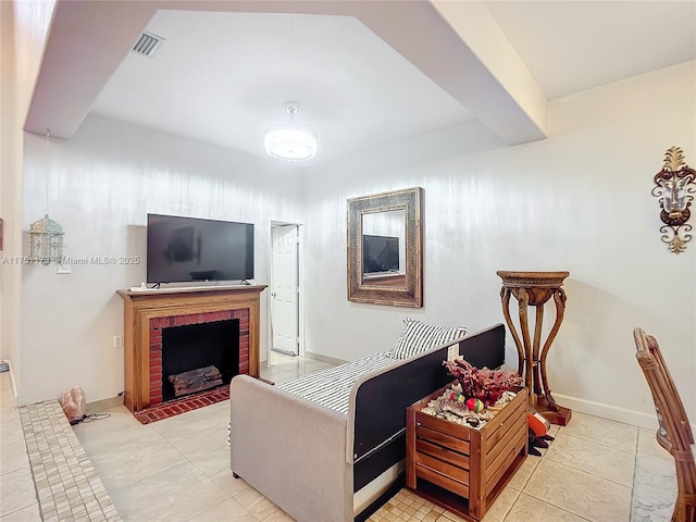 living room with a brick fireplace, visible vents, baseboards, and light tile patterned floors