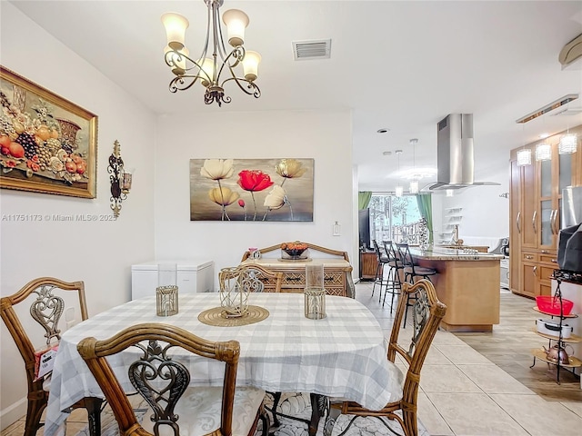 dining area with light tile patterned floors, visible vents, and an inviting chandelier