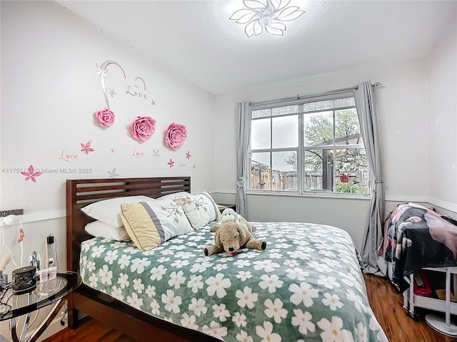 bedroom with dark wood finished floors