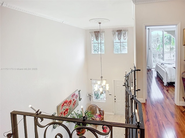 interior space featuring baseboards, a chandelier, and wood finished floors