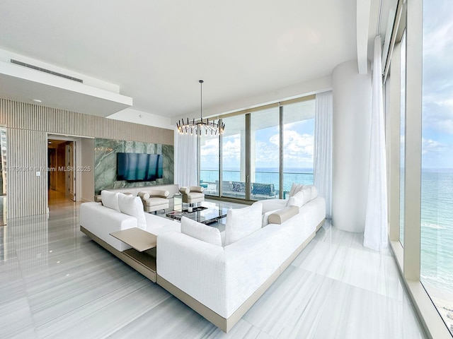 living area featuring a notable chandelier and wallpapered walls