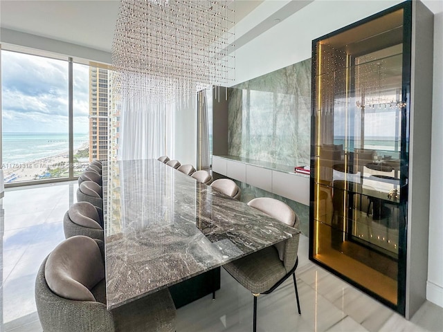 tiled dining room featuring plenty of natural light and a water view