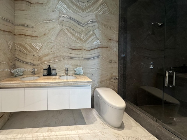bathroom with a shower stall, double vanity, and toilet