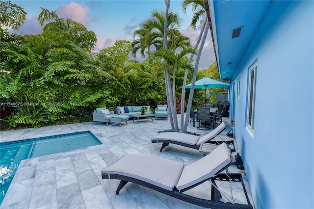 outdoor pool featuring a patio, outdoor dining space, and an outdoor living space