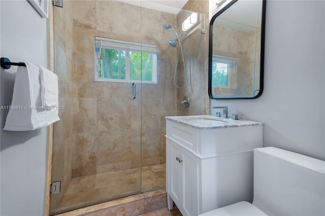 full bathroom with toilet, a shower stall, and vanity