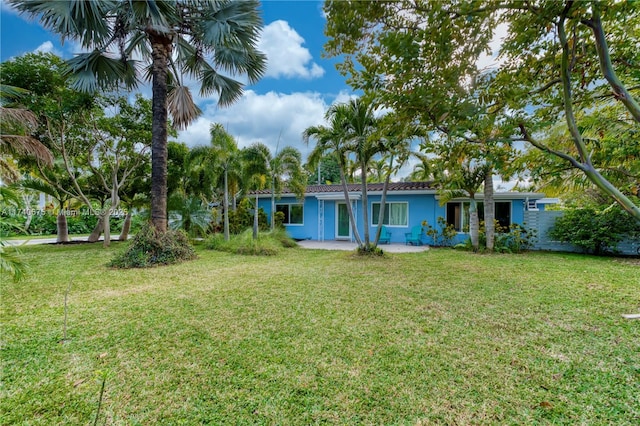 rear view of property with a lawn and stucco siding