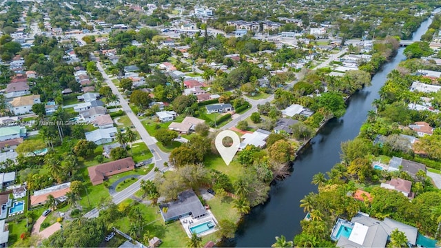 drone / aerial view featuring a water view and a residential view