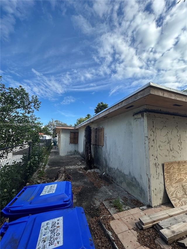 view of property exterior featuring fence