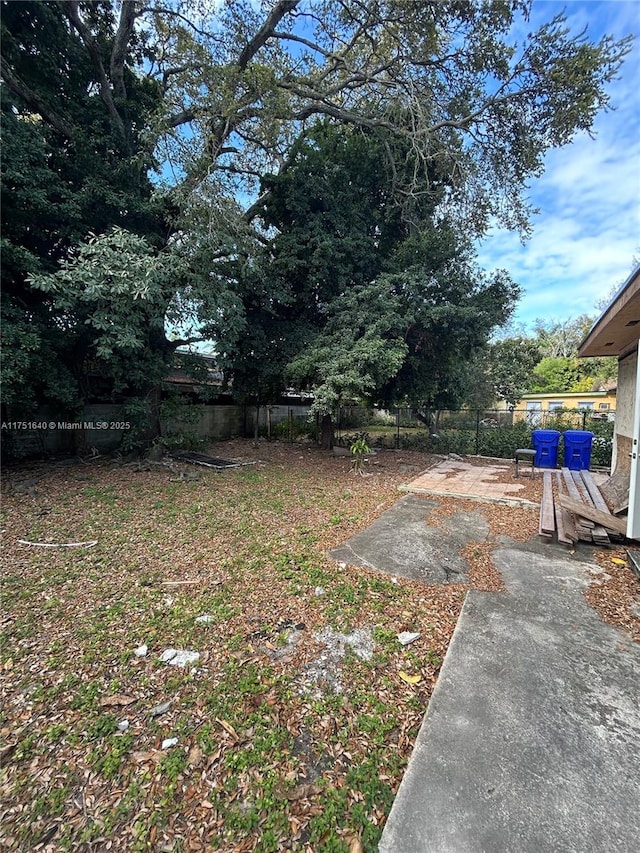 view of yard featuring fence and a patio