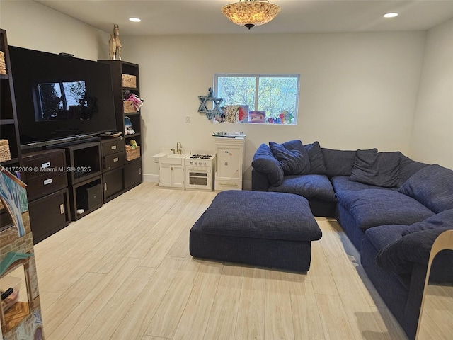 living room featuring light wood-type flooring and recessed lighting