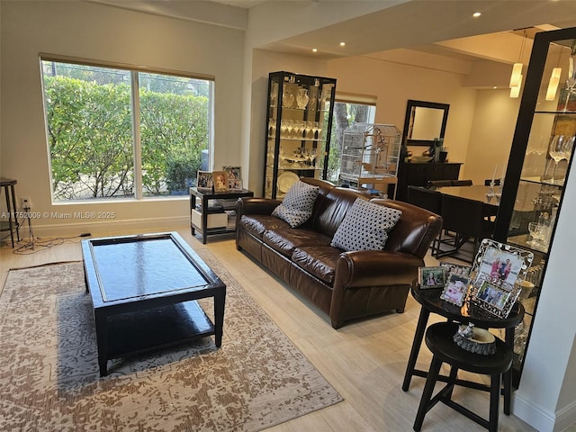 living area with light wood finished floors, baseboards, and recessed lighting