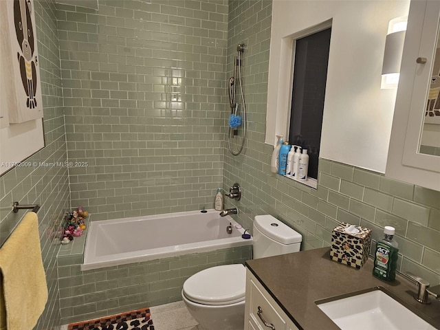 full bathroom featuring tiled shower / bath, toilet, vanity, and tile walls