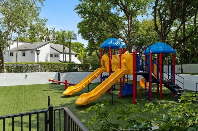 community playground with fence and a lawn