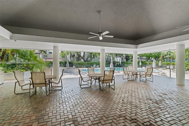 view of patio featuring a ceiling fan and a community pool