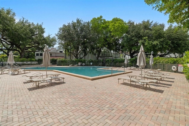 community pool featuring a patio area and fence