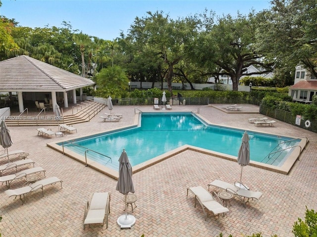 pool featuring fence, a gazebo, and a patio