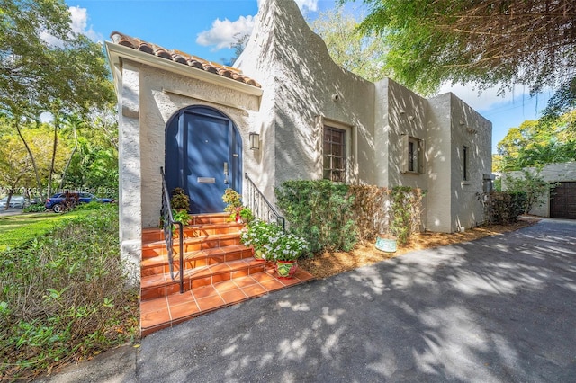 view of front of property with entry steps and stucco siding