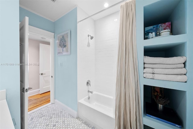 bathroom featuring shower / tub combo and baseboards