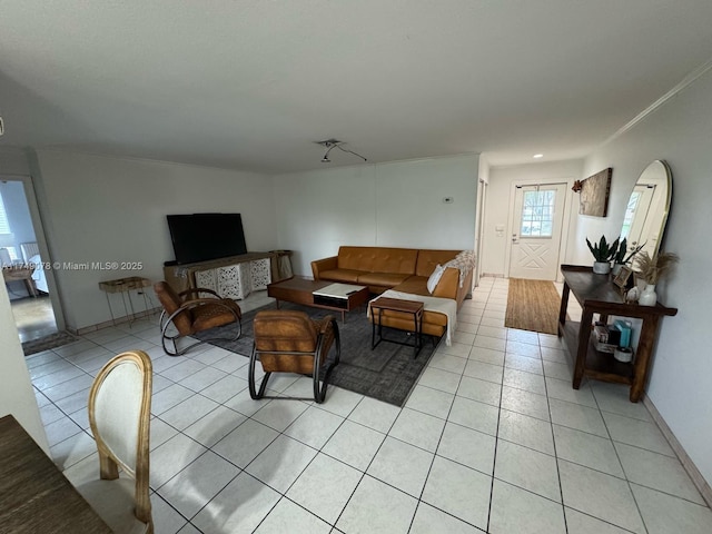 living area featuring baseboards, crown molding, and light tile patterned flooring