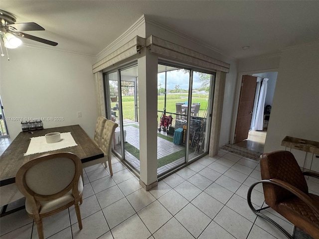 dining area with a healthy amount of sunlight, light tile patterned floors, a ceiling fan, and crown molding