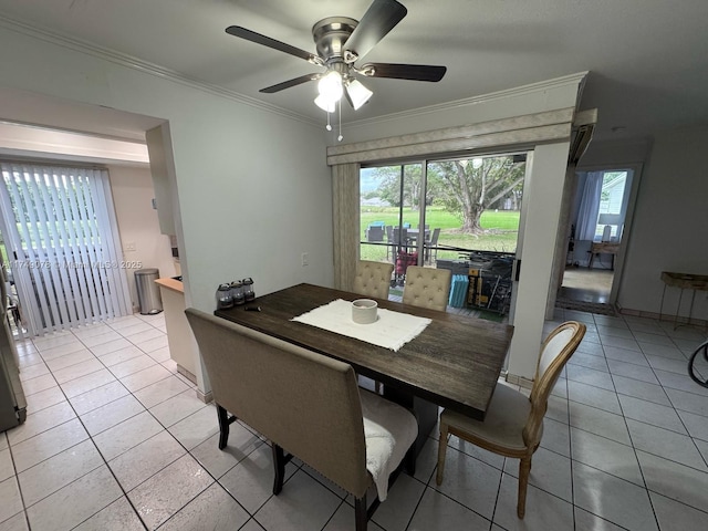 dining space featuring light tile patterned floors, a ceiling fan, and crown molding