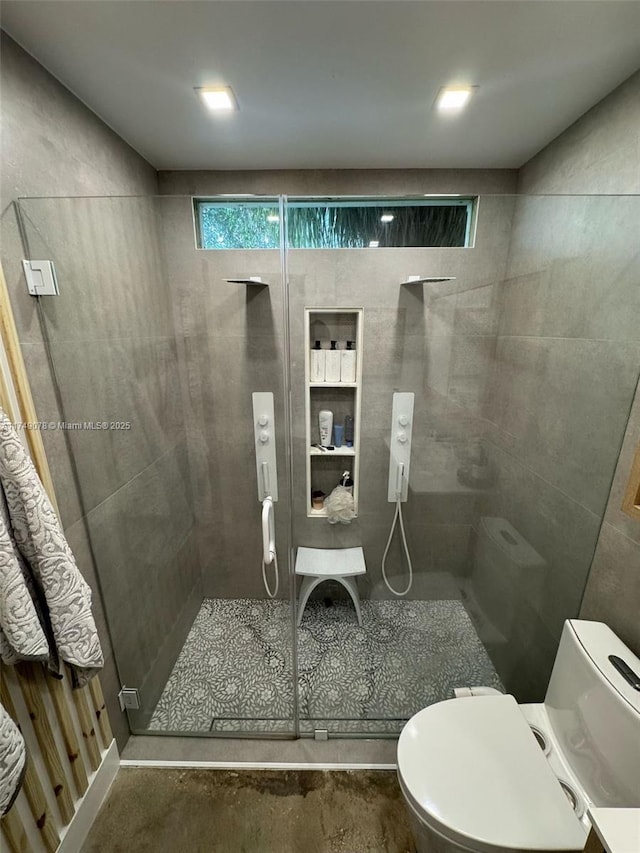 bathroom with a stall shower and toilet