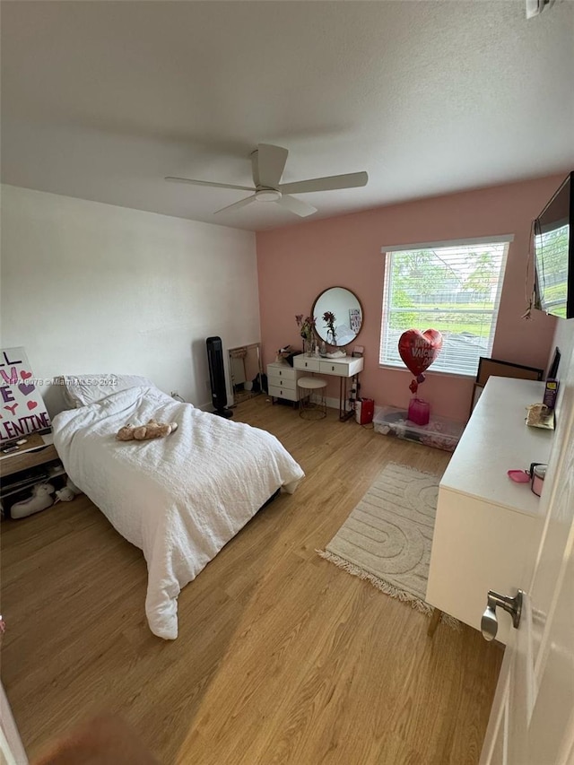 bedroom with ceiling fan and wood finished floors