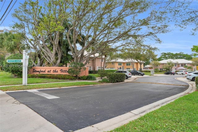 view of street featuring a residential view, curbs, and sidewalks