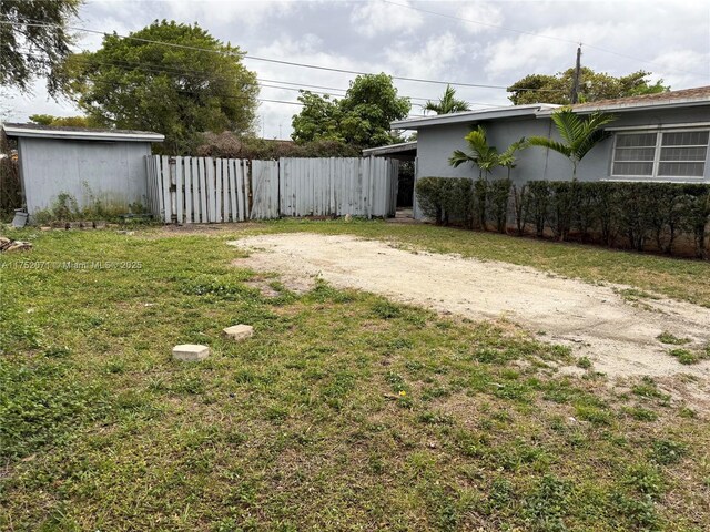 5360 Fletcher St, Hollywood, FL 33021 - view of yard featuring driveway and fence