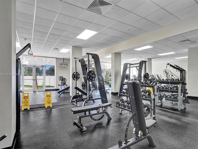 exercise room with visible vents and a drop ceiling