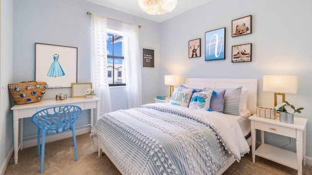 bedroom with a chandelier and carpet