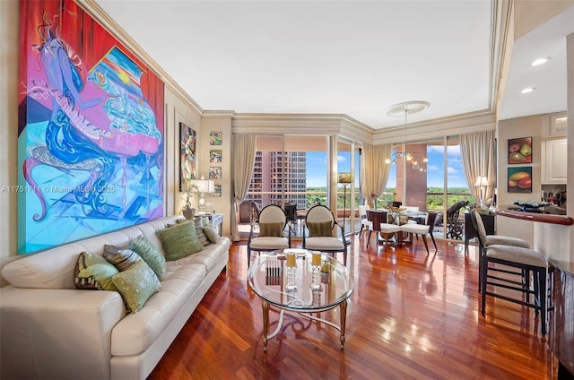 living area featuring crown molding, a notable chandelier, and wood finished floors