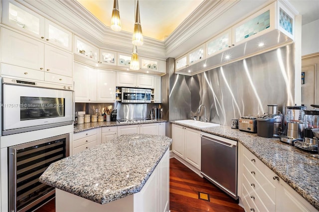 kitchen with beverage cooler, glass insert cabinets, stainless steel appliances, and a sink